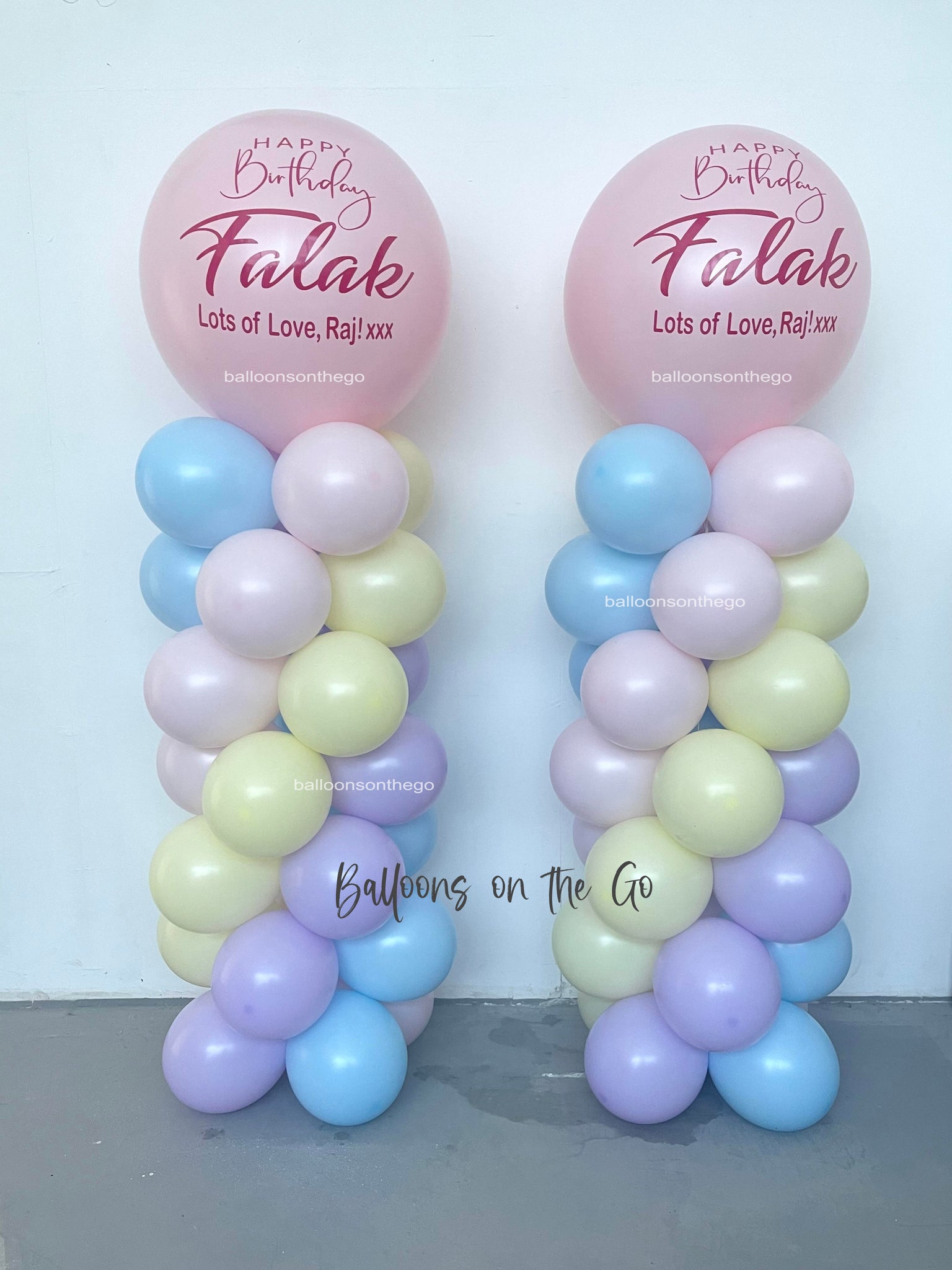 Pastel balloon towers with gaint customized balloon